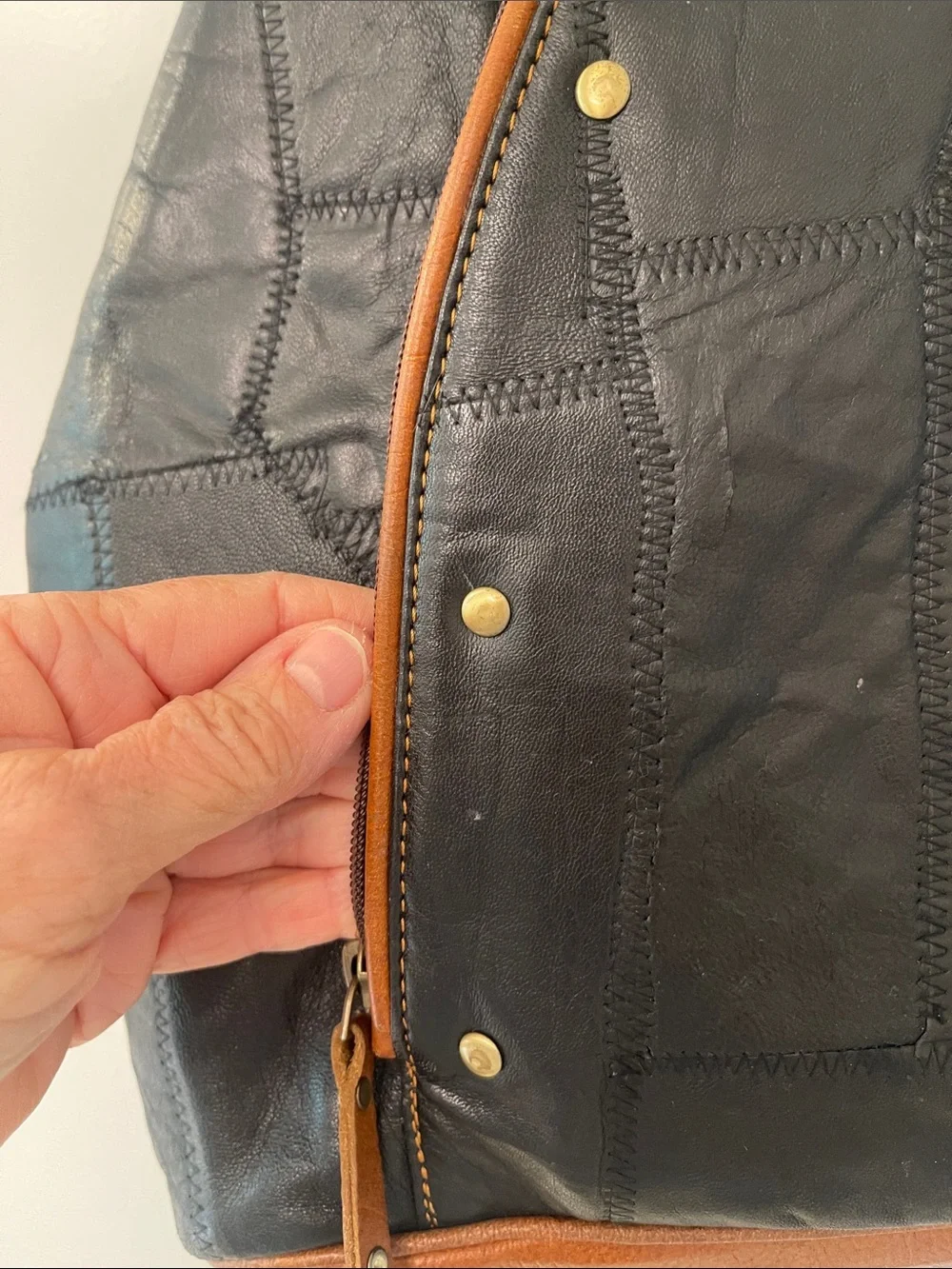 Black Leather Backpack with Brown Trim and Brass Accents
